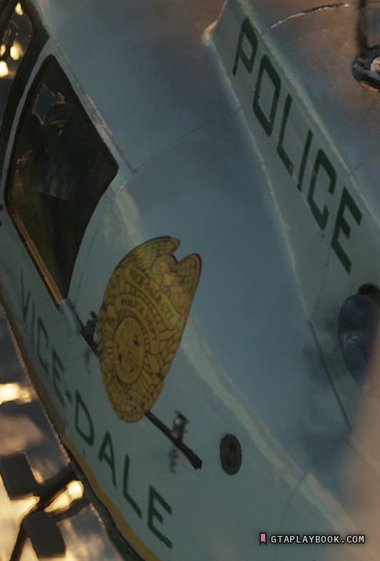 The police helicopter over the water at 2:27.30: VICE-DALE in dark green capitals along the cabin flank, a gold shield badge with an eagle above it, POLICE across the engine deck
